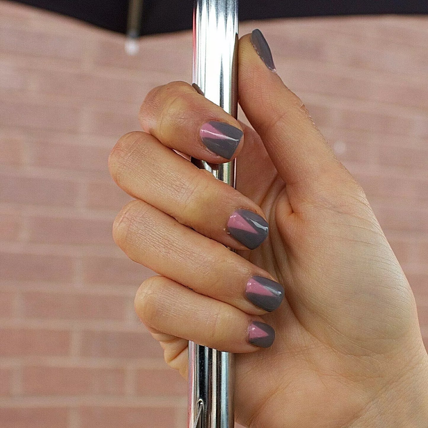 Fingers painted with Bio Sculpture Gemini Nail Polish No. 126 Savannah Dusk on light skin – breathable, muted mauve polish for a polished, versatile style