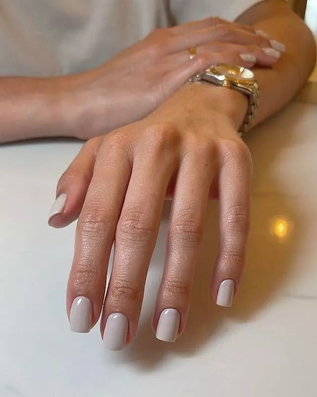 Hand with light skin tone wearing Bio Sculpture Mute – gentle, vegan muted nude polish for a natural, sophisticated manicure