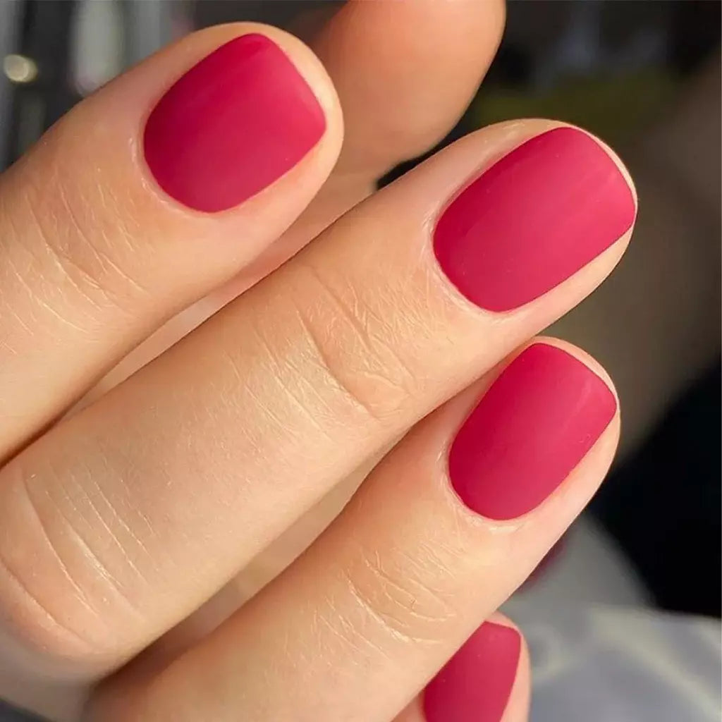 Hand wearing Bio Sculpture Gemini Nail Polish No. 211 Wild at Heart – bold, vegan berry undertone polish for inclusive, radiant manicures
