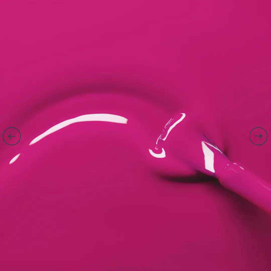 Polish brush dipped in Manucurist Armeria nail polish – creamy, non-toxic pink formula for smooth application