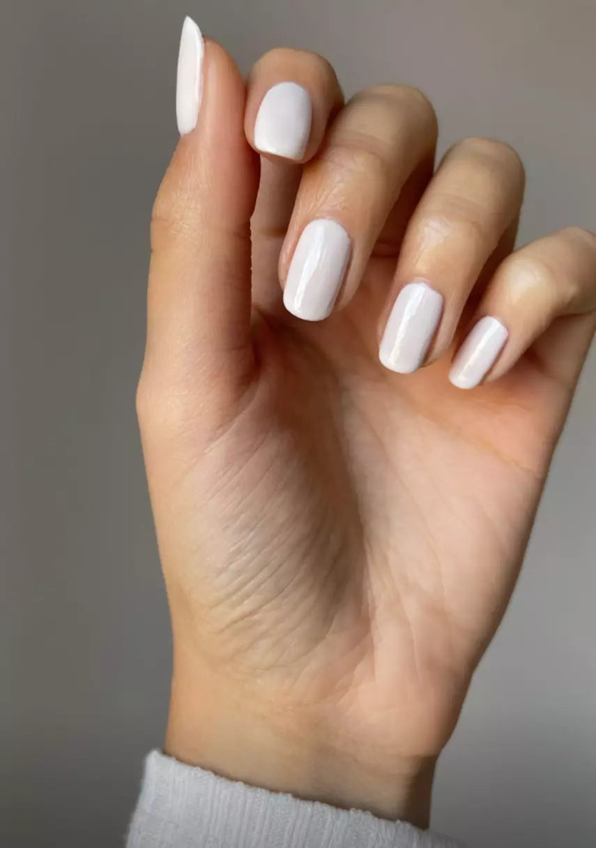 Hand with light skin tone wearing Nailberry Almond – soft, non-toxic almond nude polish for a chic, understated nail look