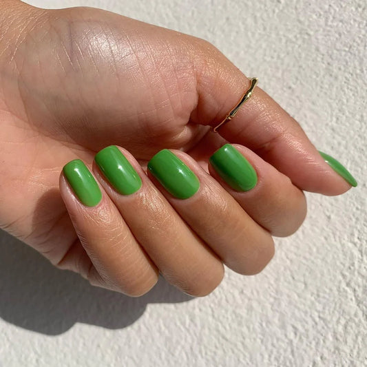 Close-up of Bio Sculpture Gemini Nail Polish No. 135 Appletini polish on light skin – non-toxic, vivid apple green shade for a chic, statement nail look