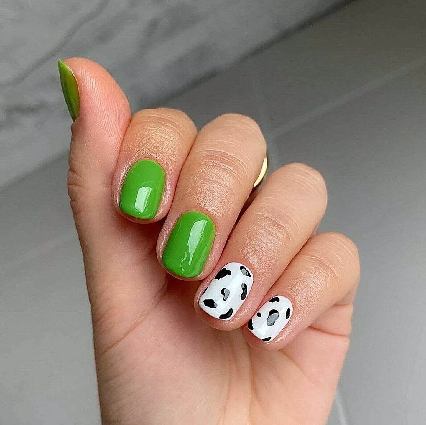 Fingers painted with Bio Sculpture Gemini Nail Polish No. 135 Appletini on light skin – breathable, apple green polish for a playful, everyday style