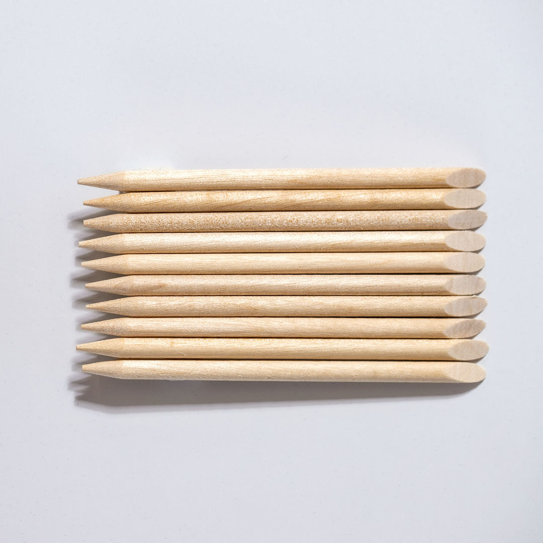 Pack of 10 orange sticks – essential wooden nail care tools for precise cuticle work and nail cleaning. Versatile, disposable tools for gentle cuticle pushing and nail art application