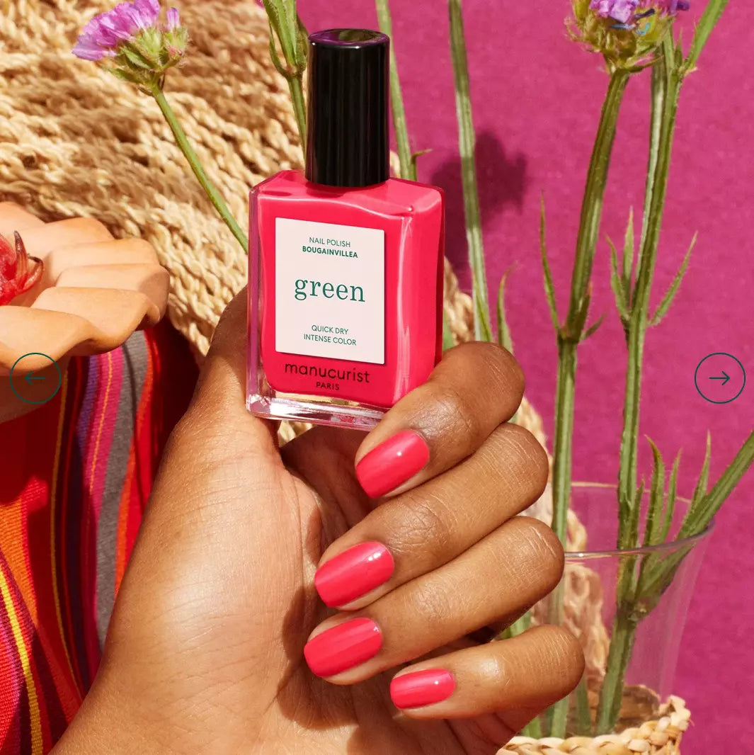 Hand holding Manucurist Paris Green Range Bougainvillea – vivid, non-toxic pink nail polish bottle for healthy nails