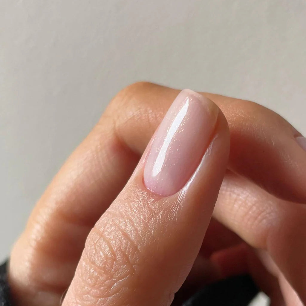 Close-up of Baby Heart Confetti polish on light skin – non-toxic, playful pink and confetti effect for a unique nail look