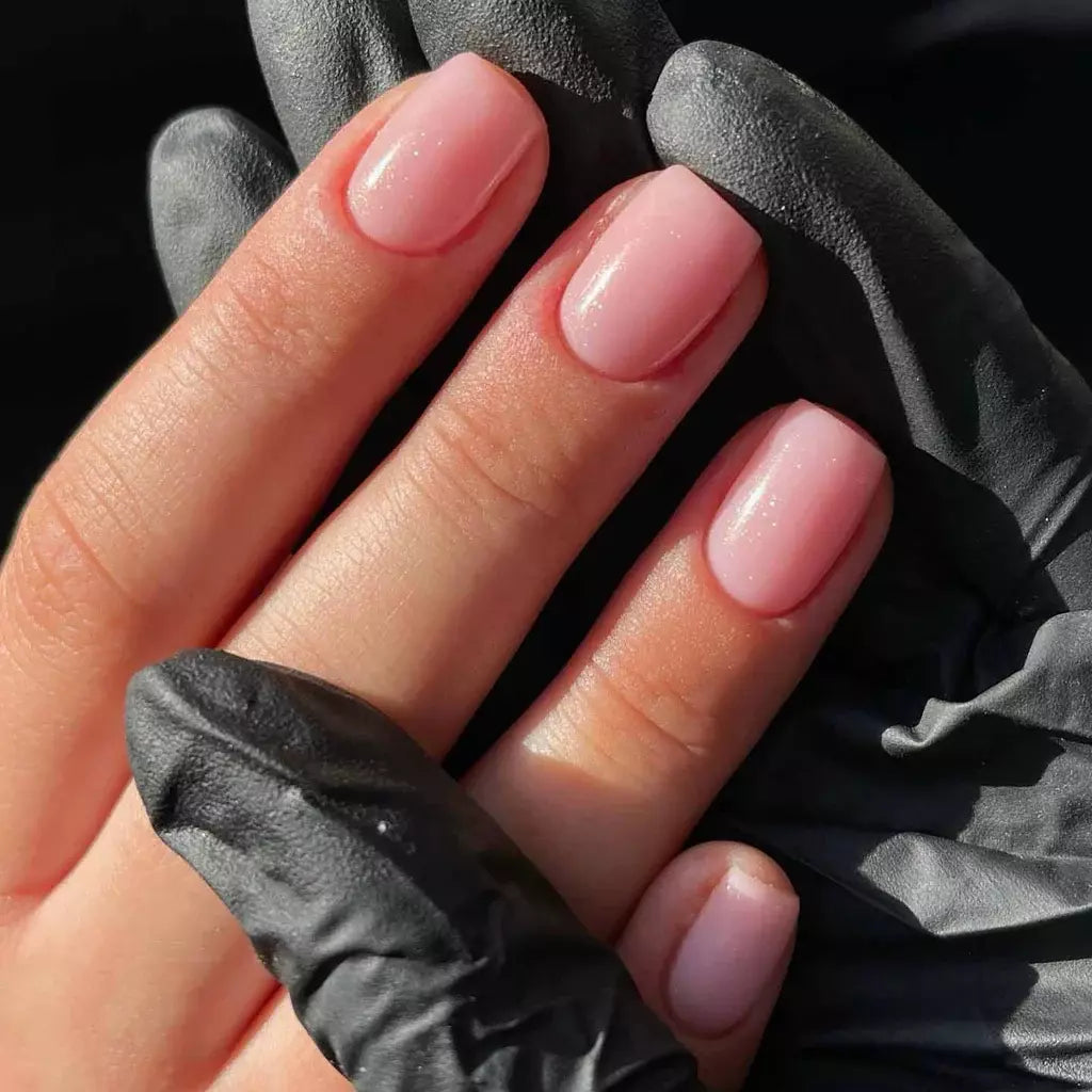 Hand with light skin tone wearing Bio Sculpture Baby Heart Confetti – vegan, pink confetti polish for a cheerful, whimsical manicure
