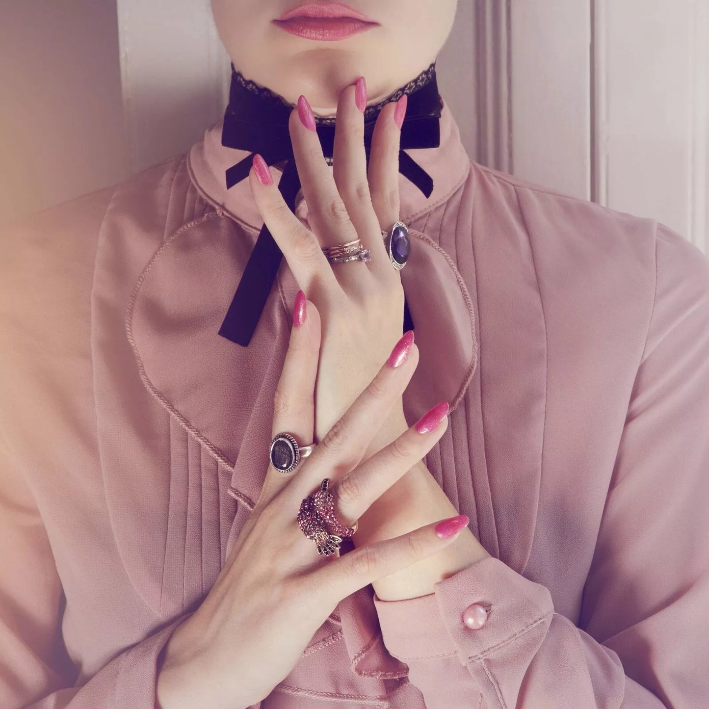 Hand wearing Bio Sculpture Gemini Nail Polish No. 214 Bring Out The Beauty – bold, vegan show stopping pink glitter polish for inclusive, radiant manicures