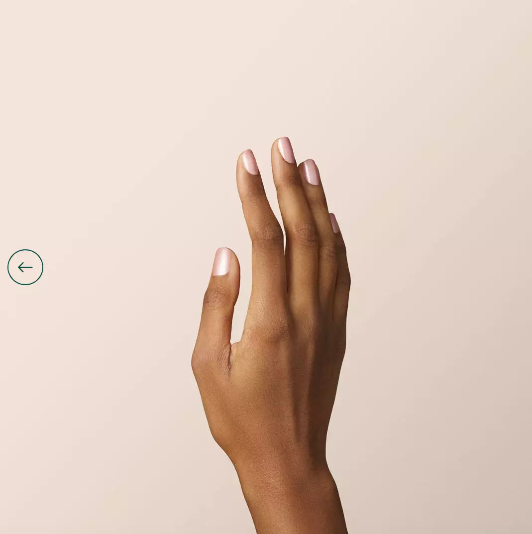 Hand showcasing Carnation nail polish by Manucurist – soft, plant-based pink for a modern, understated style