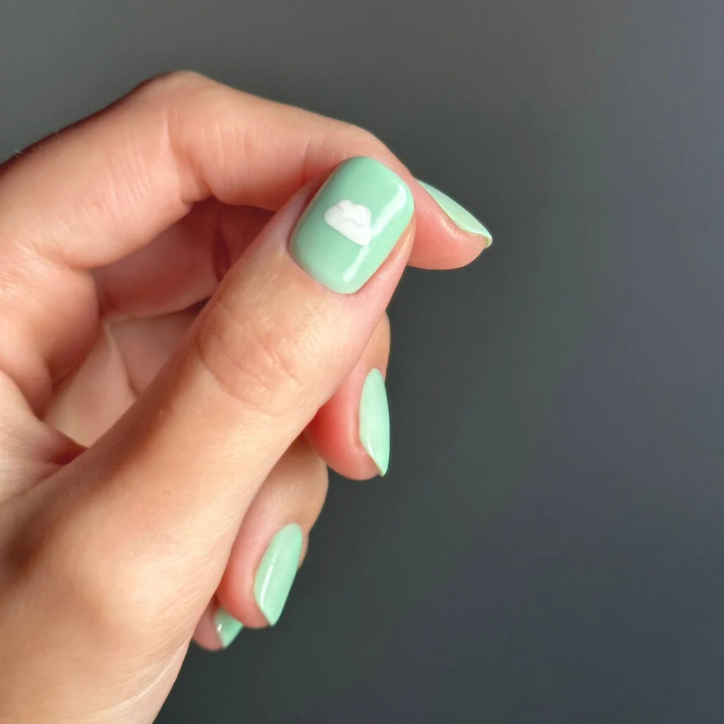 Fingers painted with Gemini Cloudcha on light skin – breathable, pastel blue polish for a chic, everyday style
