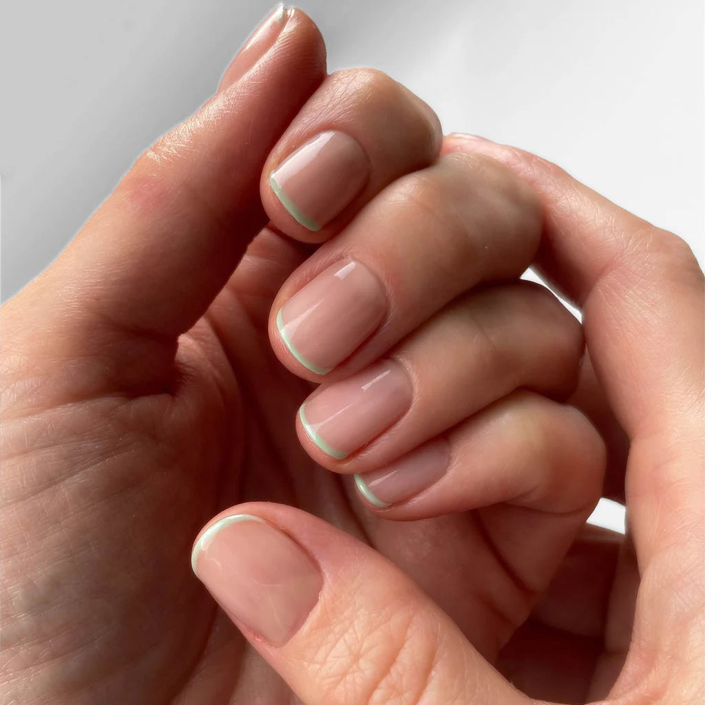 Close-up of Cloudcha polish on dark skin – eco-friendly, pastel blue shade for a radiant nail look