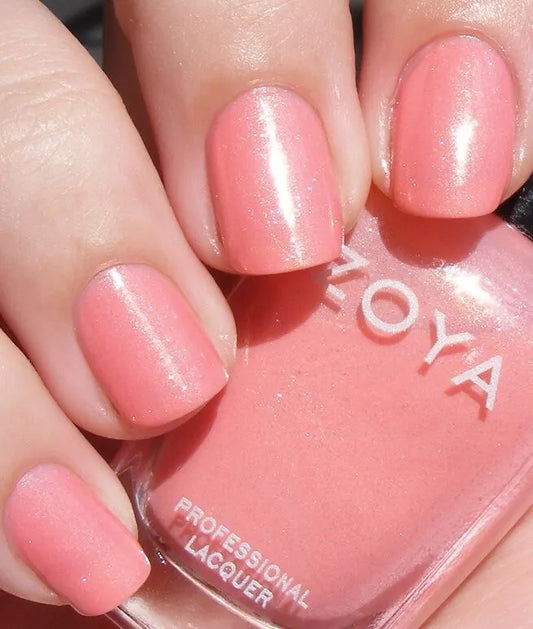 Hand holding Zoya Rue nail polish – vegan, nude pink polish bottle for elegant, everyday manicures