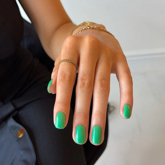 Hand with light skin tone wearing Bio Sculpture Gemini Nail Polish No. 198 Catch the Wind – vegan, dark mint green polish for a chic, contemporary nail look