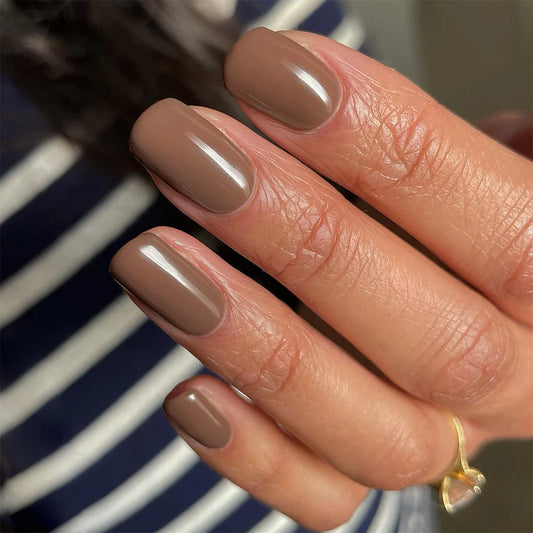 Hand wearing Bio Sculpture Gemini Nail Polish No. 111 Chocolate Fudge – vegan, creamy chocolate brown polish for a chic, sophisticated nail look