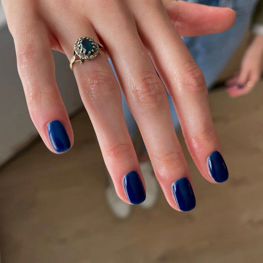 Close-up of Bio Sculpture Gemini Nail Polish No. 131 Duke polish on light skin – non-toxic, classic navy blue shade for a refined, modern nail look