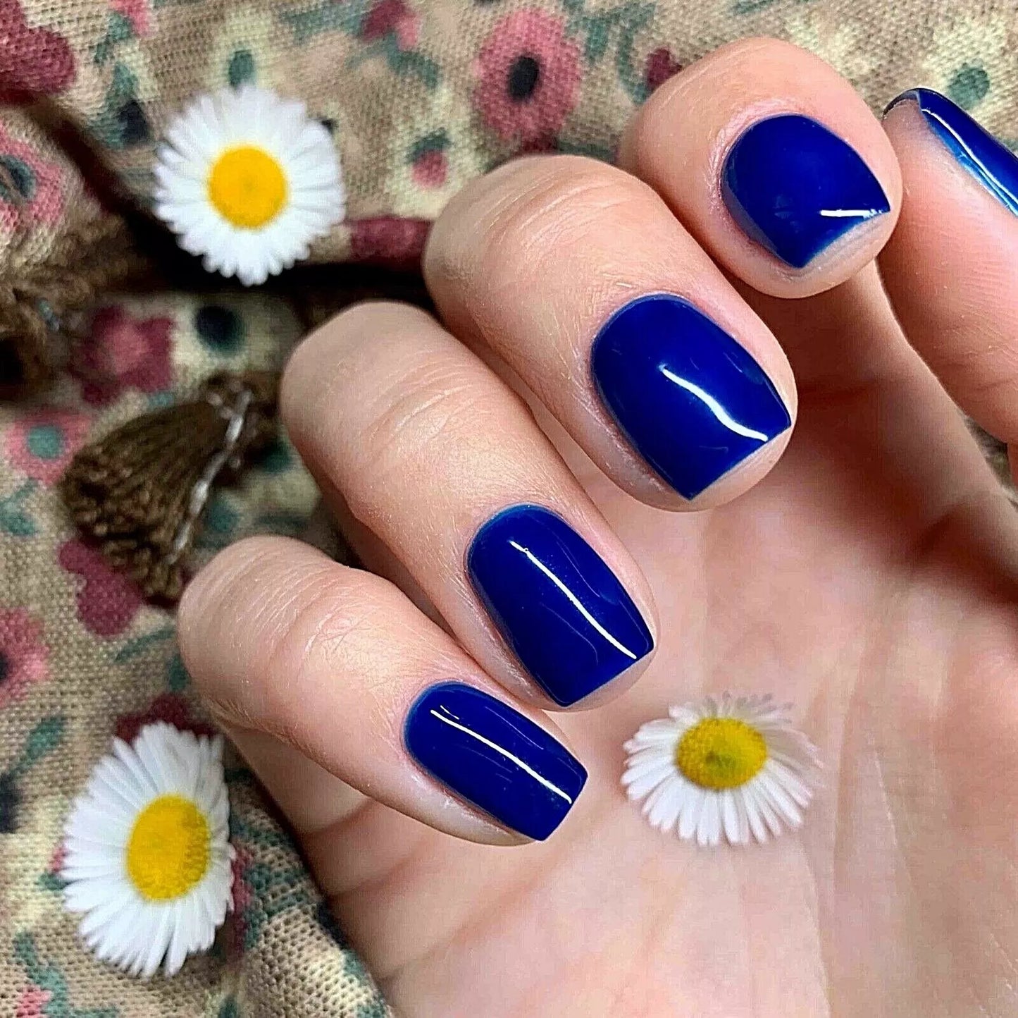Fingers painted with Bio Sculpture Gemini Nail Polish No. 131 Duke on light skin – breathable, bold navy blue polish for a polished, statement style
