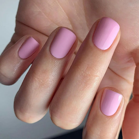 Hand wearing Bio Sculpture Gemini Nail Polish No. 157 Elizabeth – vegan, soft baby pink polish for a gentle, chic nail look