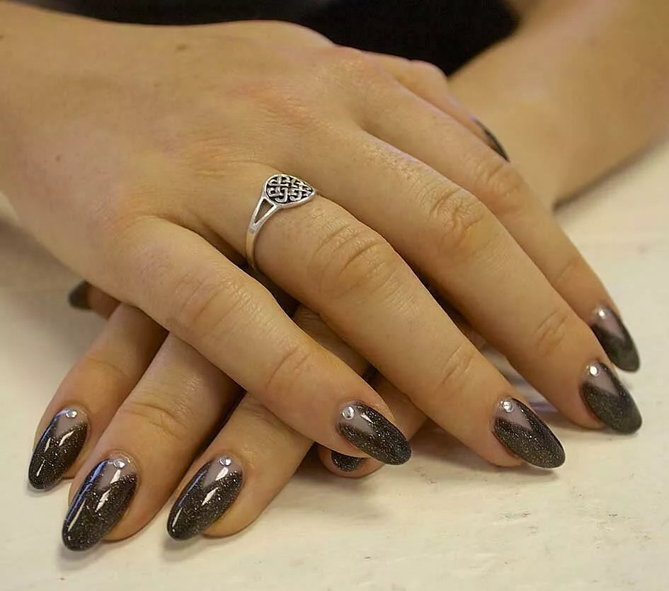 Close-up of Embellished Onyx polish on light skin – non-toxic, deep black shade with delicate shimmer for a radiant, modern nail look