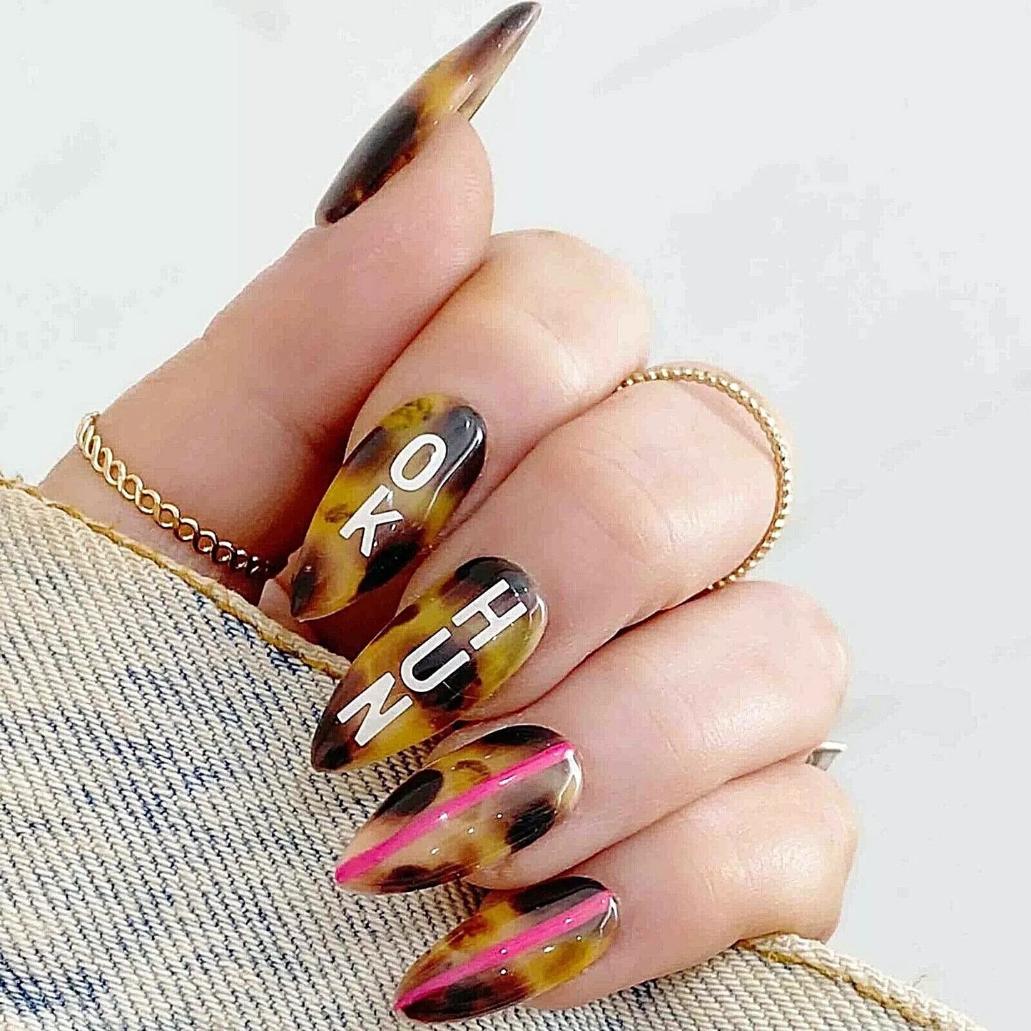 Hand showcasing Bio Sculpture Essence Glitter Love Letters Nail Art Set – sparkling glitter set for stylish, creative nails
