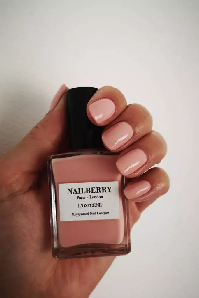 Hand wearing Nailberry Flapper nail polish – rich, non-toxic deep red shade for elegant, sophisticated nails