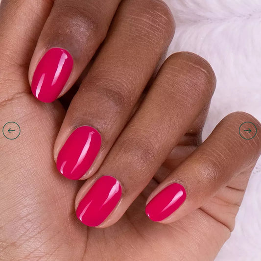 Hand with darker skin tone wearing Manucurist Fuchsia – vivid, vegan fuchsia polish for striking, inclusive manicures