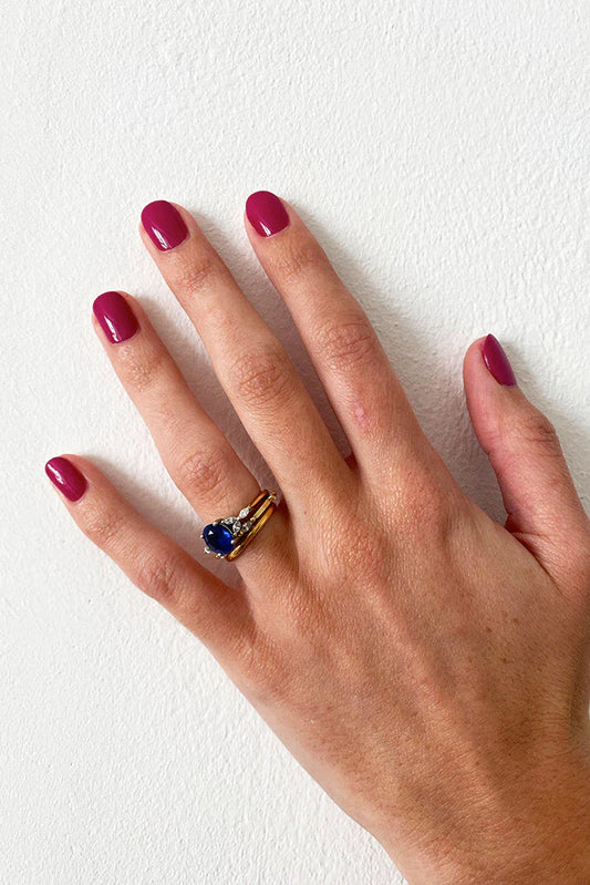 Hand with light skin tone wearing Nailberry Fuchsia in Love – vivid, non-toxic fuchsia pink polish for an eye-catching, modern nail look