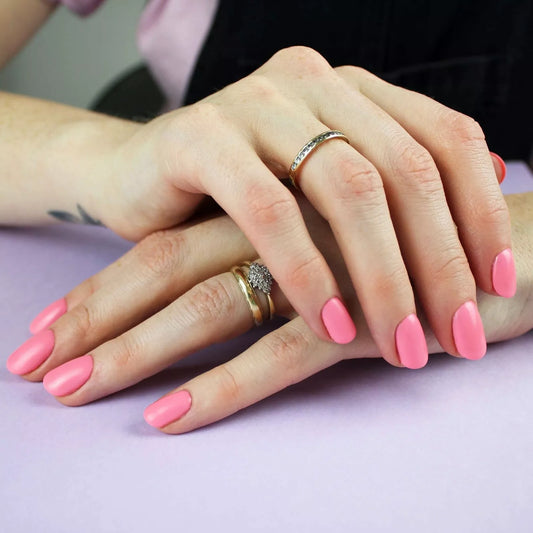 Hand wearing Bio Sculpture Gemini Nail Polish No. 195 Flower Child – vegan, pastel luminous pink polish for a chic, glowing nail look