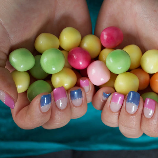 Hand wearing Bio Sculpture Gemini Nail Polish No. 108 Grapefruit Cocktail – vegan, light pink polish with lilac undertone and pearlescent sheen for a chic, radiant nail look