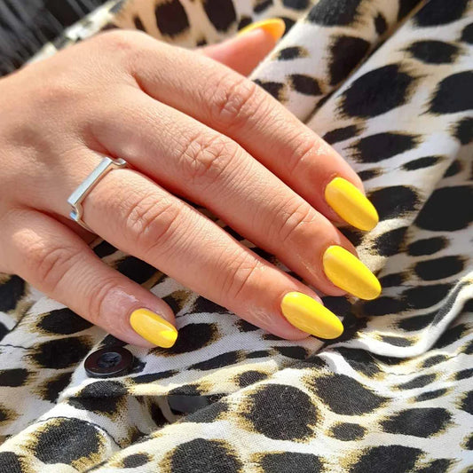 Close-up of Bio Sculpture Gemini Nail Polish No. 133 Isla Del Sol polish on light skin – non-toxic, sunny yellow shade for a bold, modern nail look