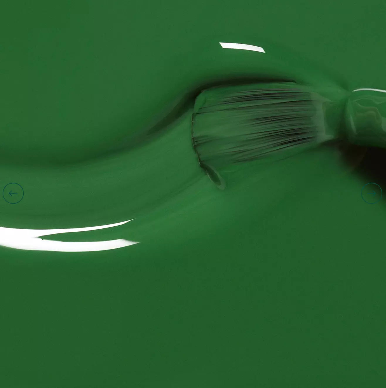 Polish brush dipped in Manucurist Jade nail polish – creamy, non-toxic jade green formula for smooth application