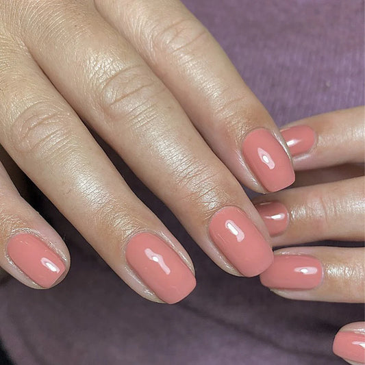 Hand with light skin tone wearing Bio Sculpture Gemini Nail Polish No. 14 Jodi Rose – vegan, light dusty pink polish for a chic, delicate nail look