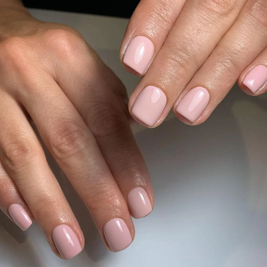 Hand wearing Bio Sculpture Gemini Nail Polish No. 235 Love – vegan, pastel pink polish for a chic, delicate nail look