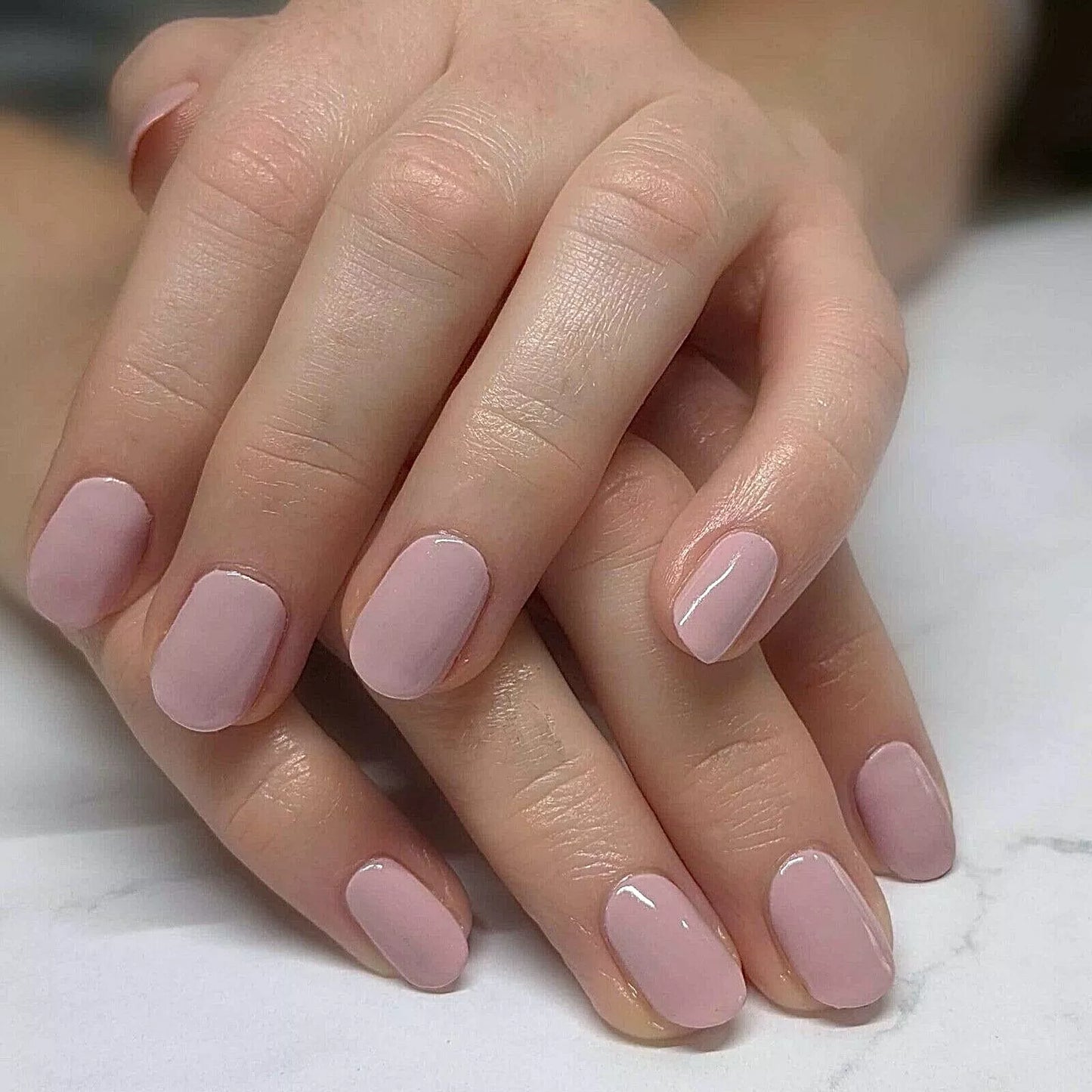 Hand wearing Bio Sculpture Gemini Nail Polish No. 235 Love – vegan, pastel pink polish for a fresh, elegant manicure