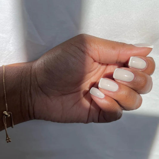 Nails featuring Bio Sculpture Mute on dark skin – breathable, cruelty-free nude polish for a sophisticated finish