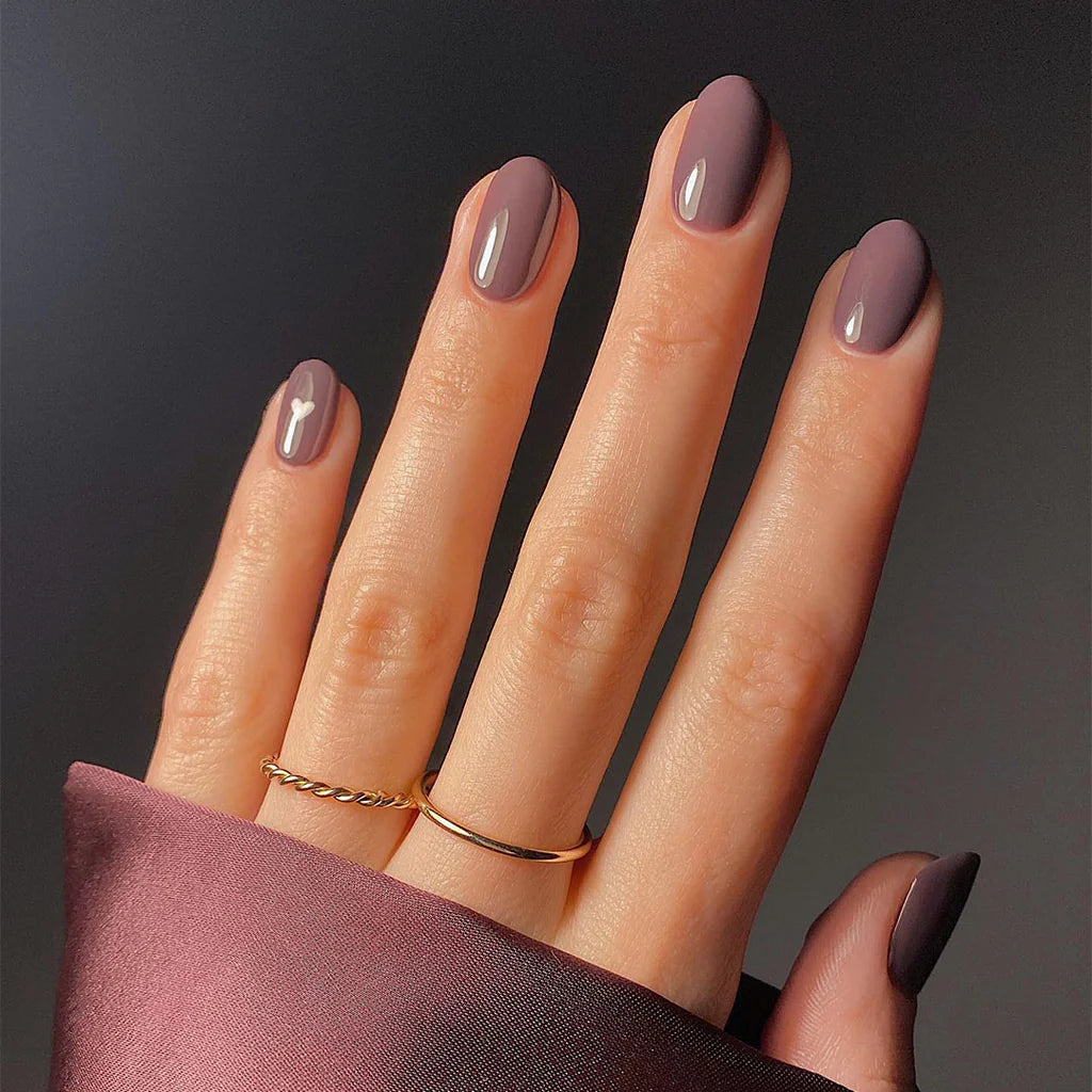 Hand wearing Bio Sculpture Gemini Nail Polish No. 254 Mauve Regalia – vegan, creamy mauve polish for a chic, sophisticated nail look