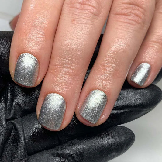 Close-up of Bio Sculpture Gemini Nail Polish No. 138 Melting Mercury polish on light skin – non-toxic, shimmering silver shade for a radiant, contemporary nail look