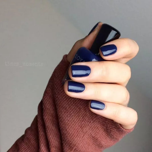 Close-up of Sailor polish on light skin – non-toxic, deep navy shade for a sophisticated nail look