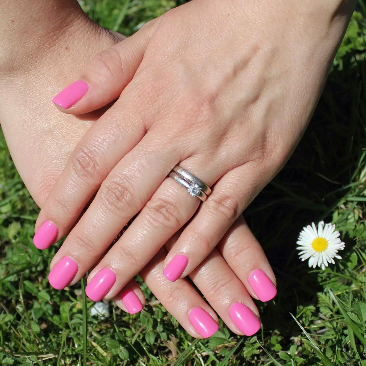Hand wearing Bio Sculpture Gemini Nail Polish No. 2027 Perfect Pink – vegan, captivating hot pink polish for a chic, statement nail look