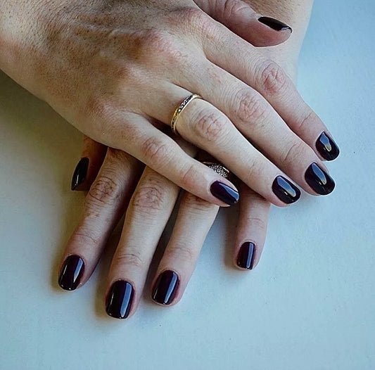 Close-up of Bio Sculpture Gemini Nail Polish No. 2031 Black Aubergine polish on light skin – non-toxic, rich blackened aubergine shade for a refined, modern nail look