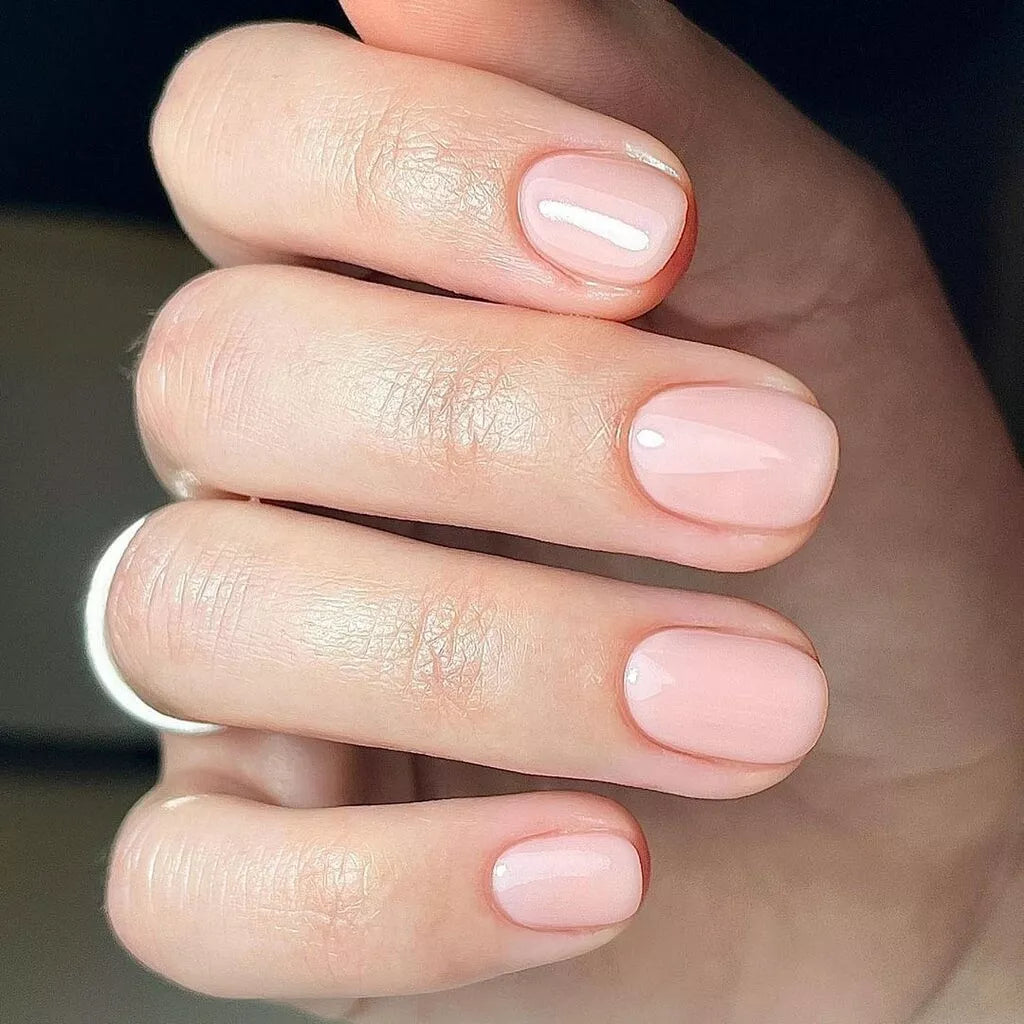 Fingers painted with Bio Sculpture Gemini Nail Polish No. 2065 Sweet Candy Breath on light skin – breathable, creamy candy pink polish for a polished, playful style