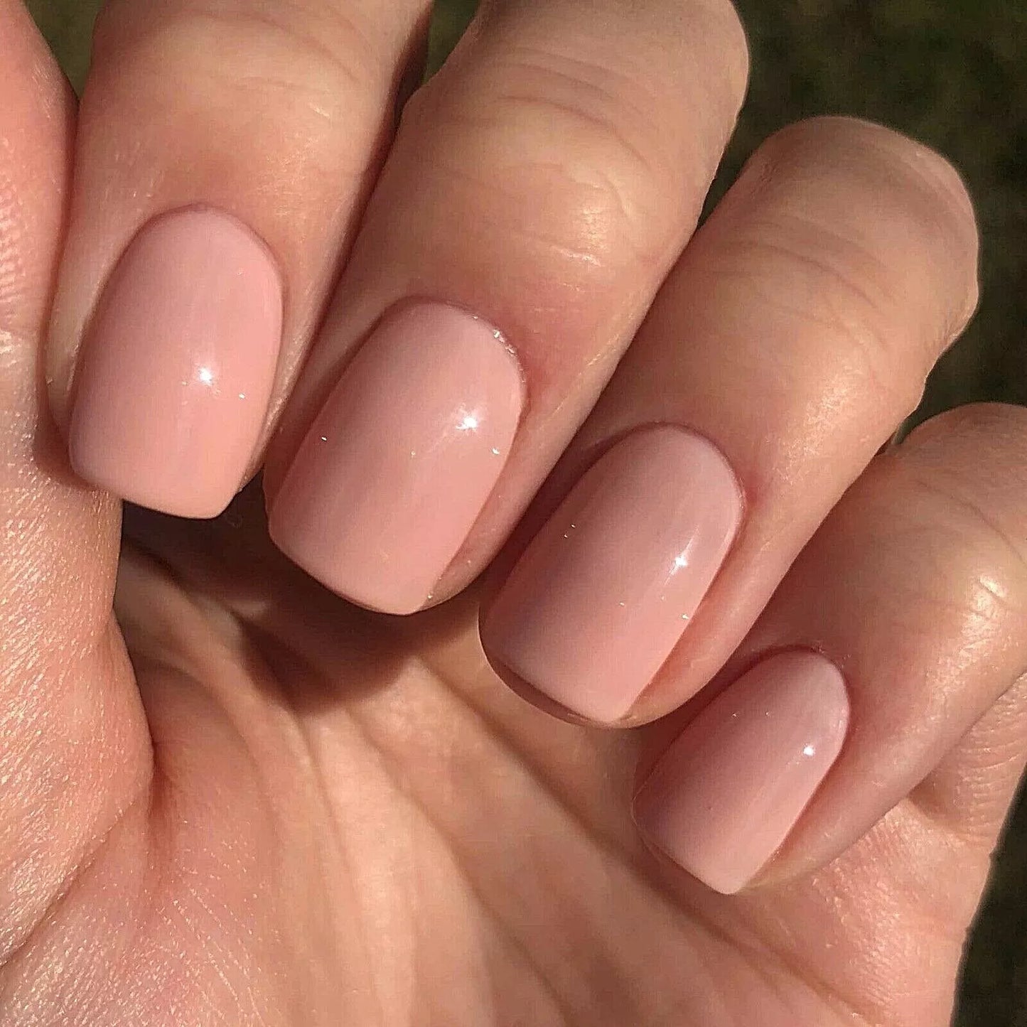 Fingers painted with Bio Sculpture Gemini Nail Polish No. 2065 Sweet Candy Breath on dark skin – non-toxic, creamy candy pink polish for a chic, versatile look