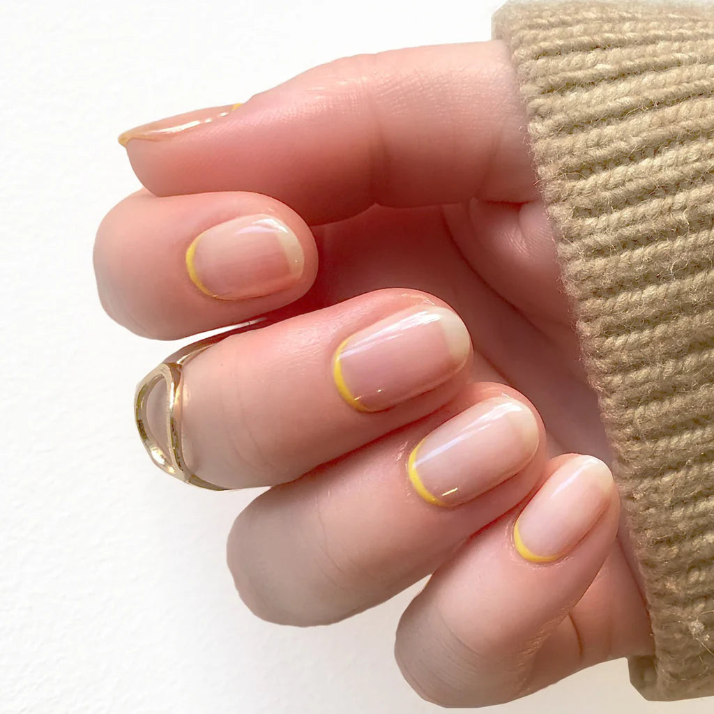 Fingers painted with Bio Sculpture Gemini Nail Polish No. 2095 Nude Beige on light skin – breathable, nude beige polish for a subtle, sophisticated style
