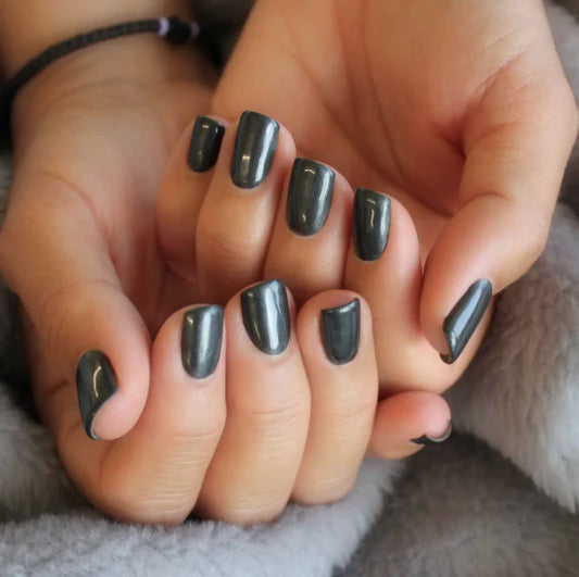 Hand wearing Bio Sculpture Gemini Nail Polish No. 253 Antique Granite – vegan, gun metal grey polish for a chic, sophisticated nail look