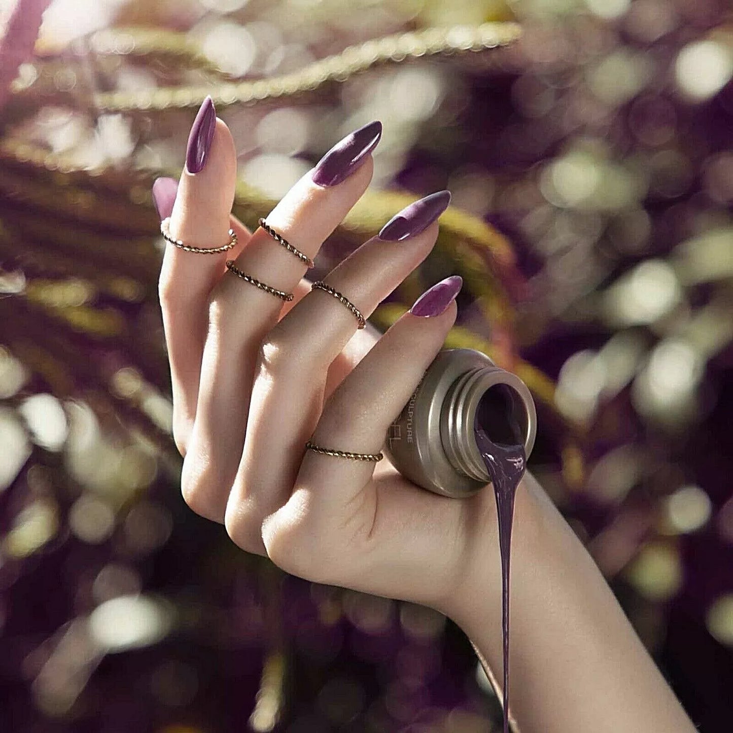 Fingers painted with Bio Sculpture Gemini Nail Polish No. 265 Chipped Bark – cruelty-free, deep purple polish for a polished, statement nail look