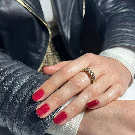 Hand with light skin tone wearing Bio Sculpture Gemini Nail Polish No. 269 Berry Bush – vegan, deep berry purple polish for a chic, sophisticated manicure