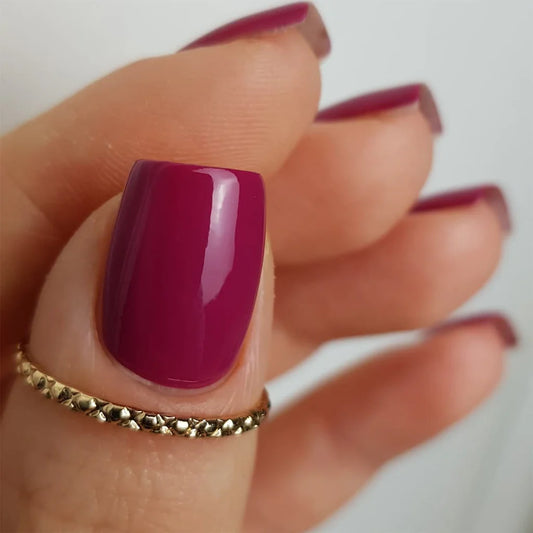 Fingers painted with Bio Sculpture Gemini Nail Polish No. 275 Prancing Protea on light skin – breathable, deep cherry red polish for a polished, everyday style