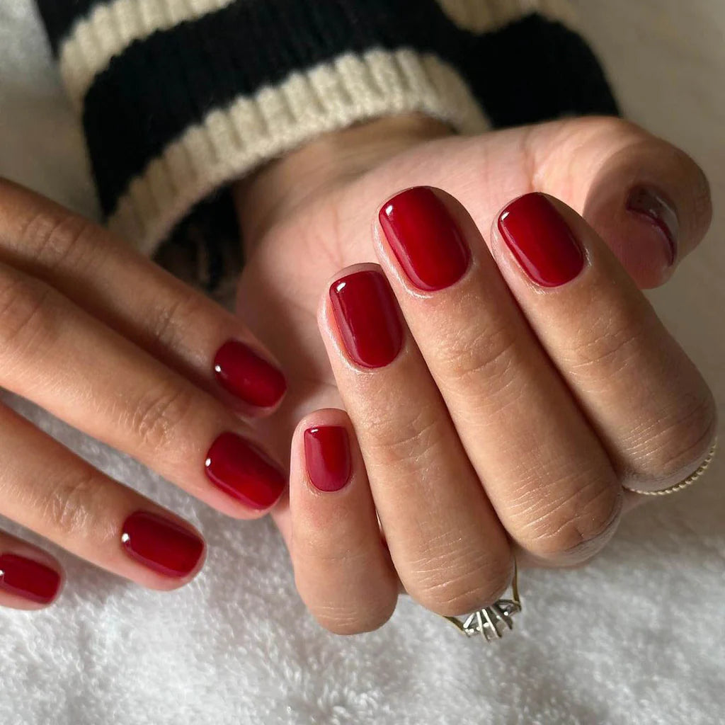 Hand with light skin tone wearing Bio Sculpture Nail Polish No. 280 A Night at the Opera – rich, vegan burgundy polish for a sophisticated, statement manicure