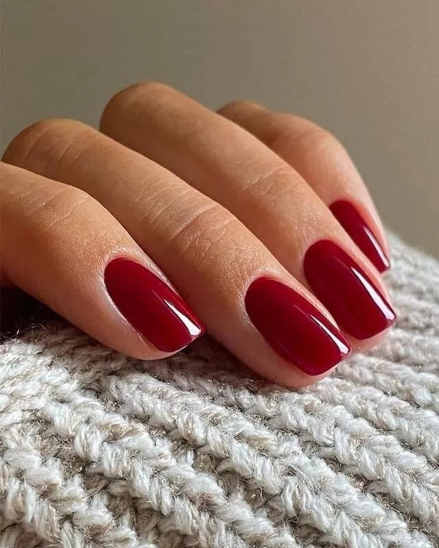 Fingers painted with Bio Sculpture Gemini A Night at the Opera Nail Polish No. 280 on light skin – breathable, classic burgundy polish for a polished, luxurious style