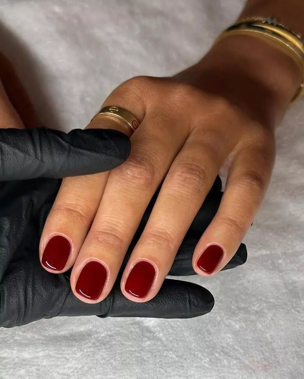 Hand wearing Bio Sculpture A Night at the Opera Nail Polish No. 280 – bold, vegan burgundy polish for inclusive, glamorous manicures