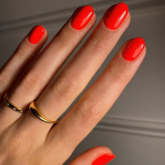 Close-up of Bio Sculpture Nail Polish No. 282, Poco Pop polish on light skin – non-toxic, vibrant coral pink shade for a chic, lively nail look
